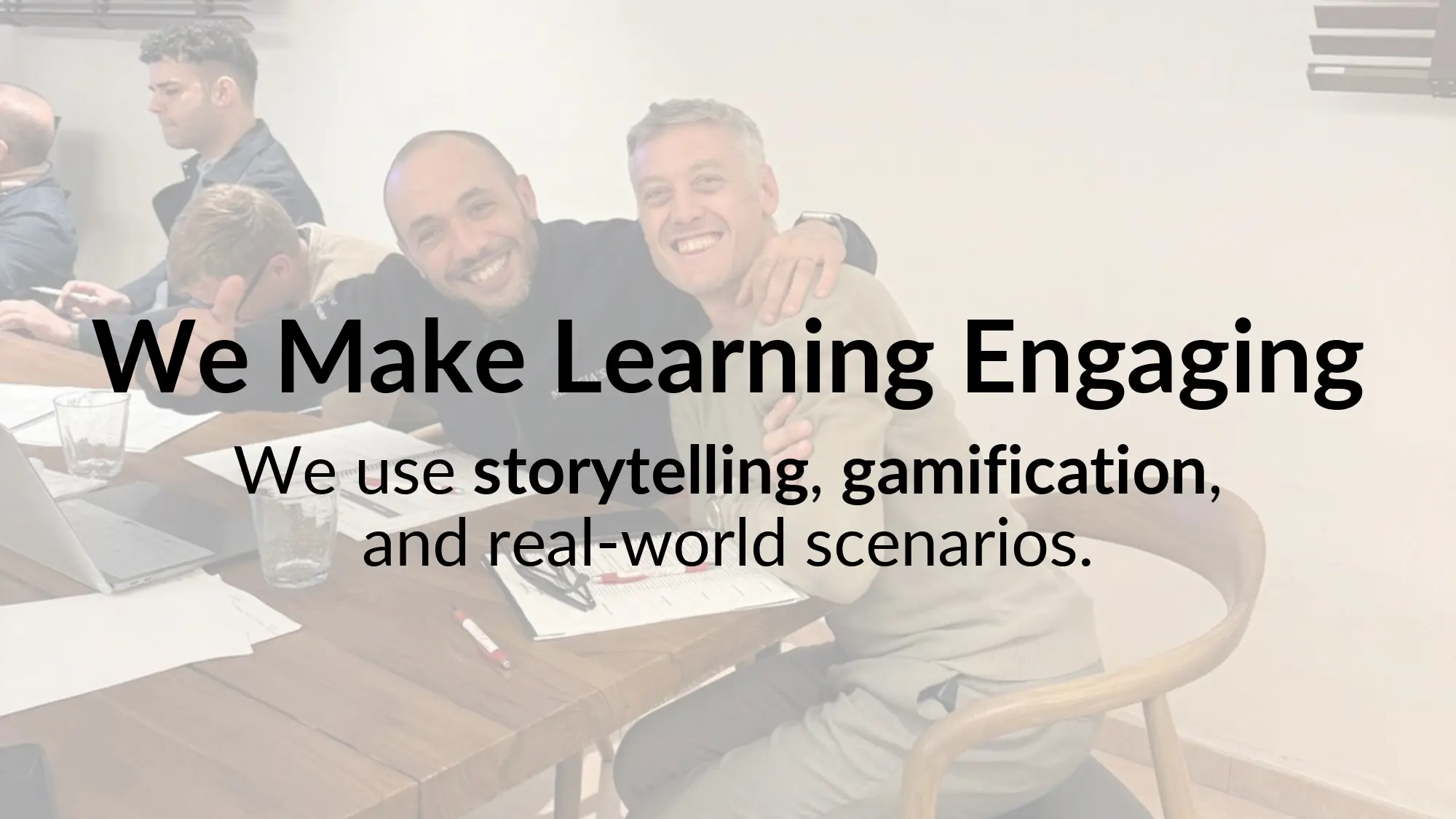 Smiling colleagues at a meeting table.