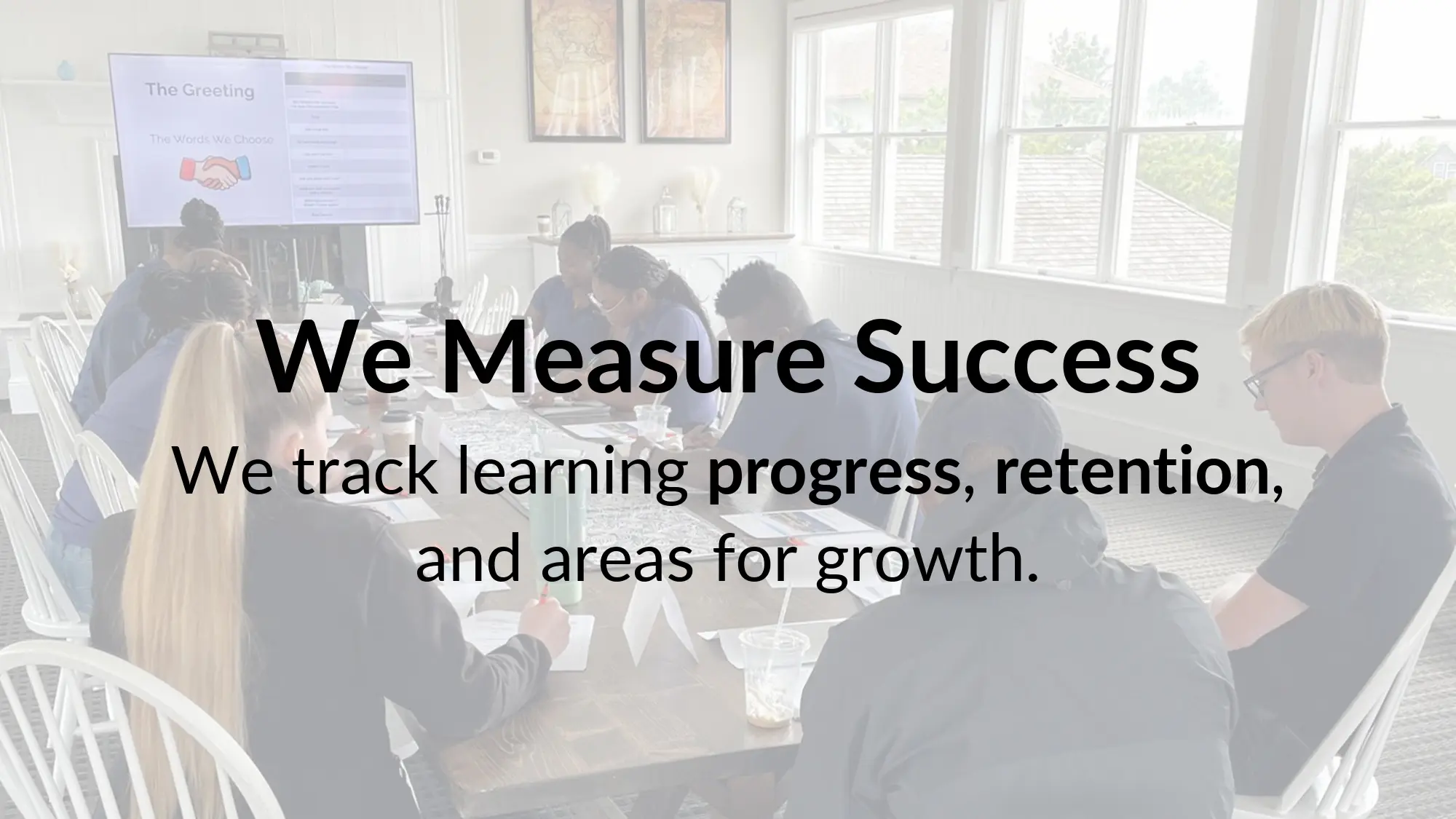 People attending a meeting with presentation.