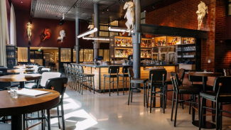 Modern bar interior with wooden tables and chairs.