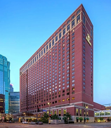 Tall brick hotel building in cityscape.