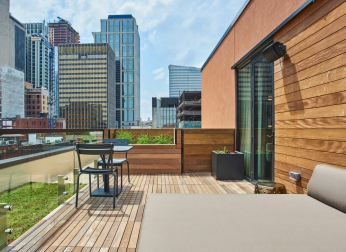 Rooftop patio with city skyline view.